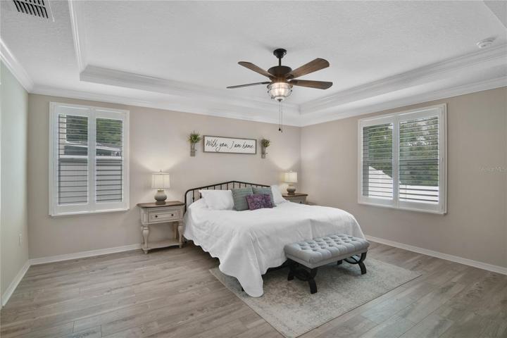 Ideal split bedrooms deliver a tranquil primary suite complete with a lovely tray ceiling, plantation shutters, WALK-IN CLOSET and private bath!