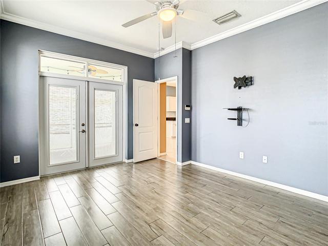 Master Bedroom Looking to the Entrance and the Private French Doors Leading to the Covered Patio and Pool to the Left