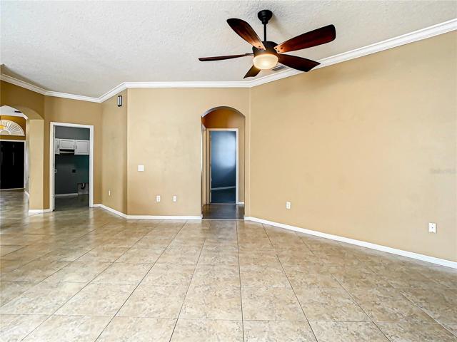 Family Room, Front Entrance to the Very Left, Then the Laundry Room Entrance, and then the Hall Leading to Bedroom Two, Three, and the Hall Full Bathroom