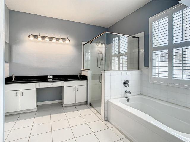 Master En Suite Bathroom With Granite Countertop, Double Sinks, Separate Shower and Tub