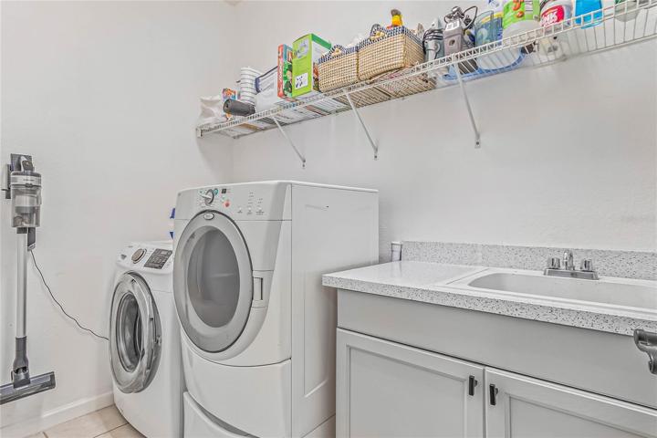Your main floor also includes a convenient half bath and spacious laundry room with built-in shelving and a utility sink with storage!