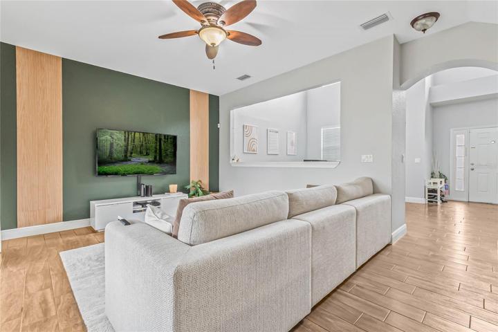 The seamless layout flows naturally into the kitchen and family room, with WOOD LOOK TILE FLOORS throughout!