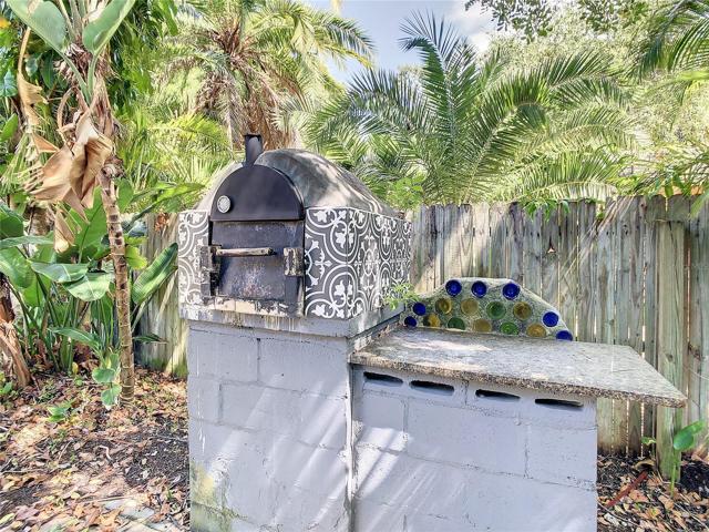 Another view of the Custom built outdoor pizza oven, with a granite counter, on the east side of the property, just outside the back door.
