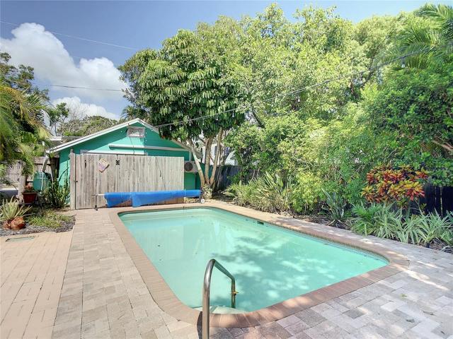 Solar heated pool. The building beyond the fence is the studio cottage. To the right of the cottage are some wooden build in sheds to house outdoor items, pool equipment, etc.