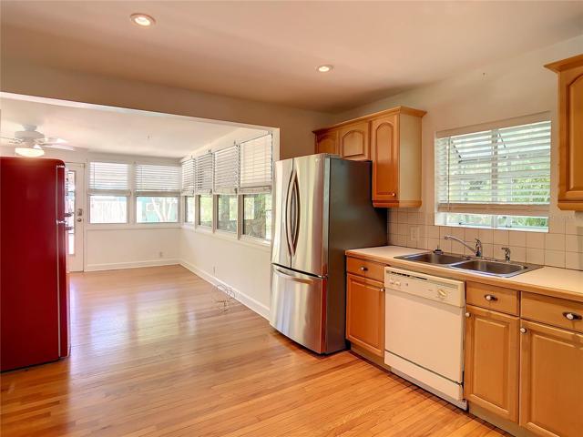 View of kitchen and Florida room from living room. Red fridge does not convey.