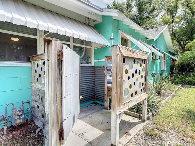 Outdoor shower. That's a one-of-a-kind shower enclosure made with cement & the bottoms of glass bottles.