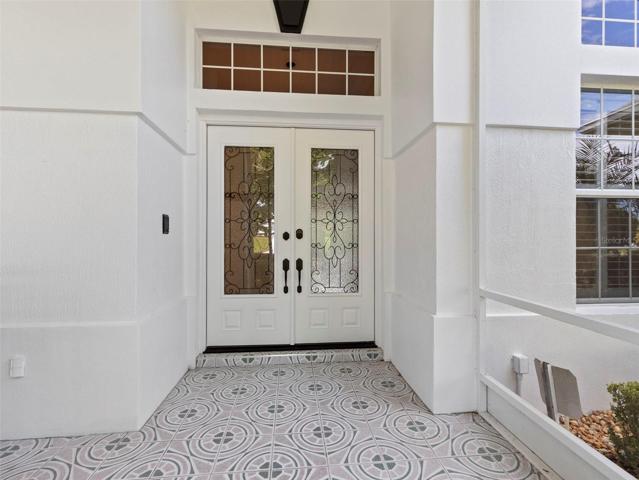 Double glass front entry doors with transom window