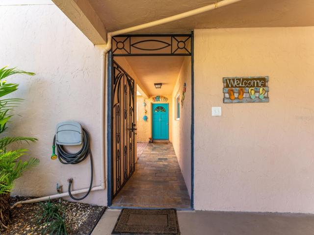 Front door through the custom wrought iron gate