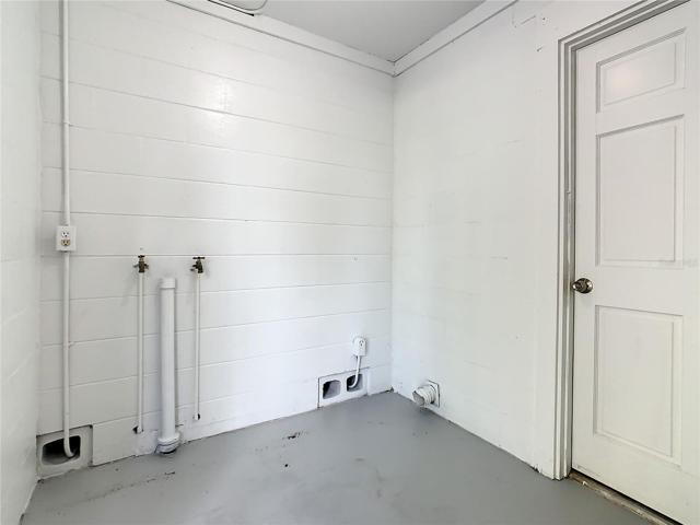 Utility room with washer dryer hook-up.