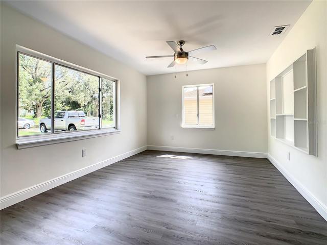 Living room has natural light from the large front window.