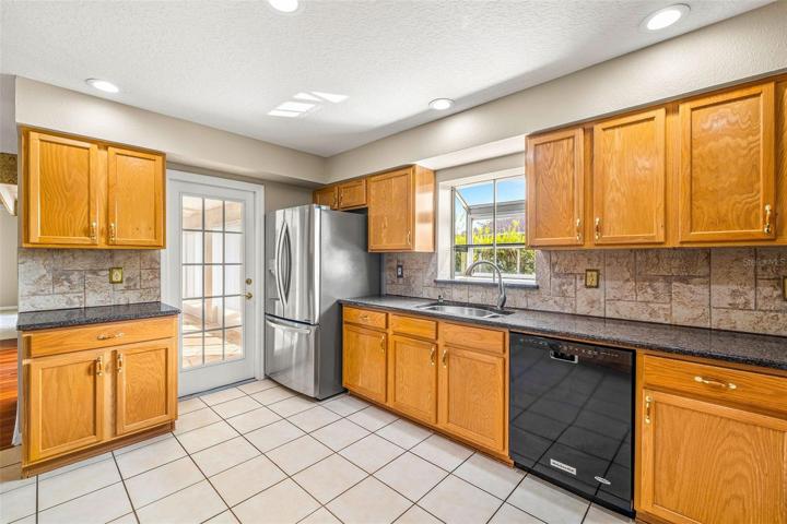 TILE BACKSPLASH, TILE FLOOR, EXIT DOOR TO THE FLORIDA ROOM OASIS!