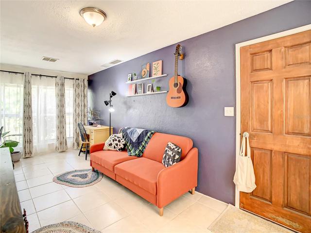 family room is light and bright with natural lighting coming from the floor-to-ceiling windows and the sliding glass doors that lead out to the back yard