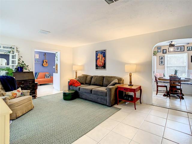 Enter the home through the formal living room that features large windows and easy maintenance tile flooring
