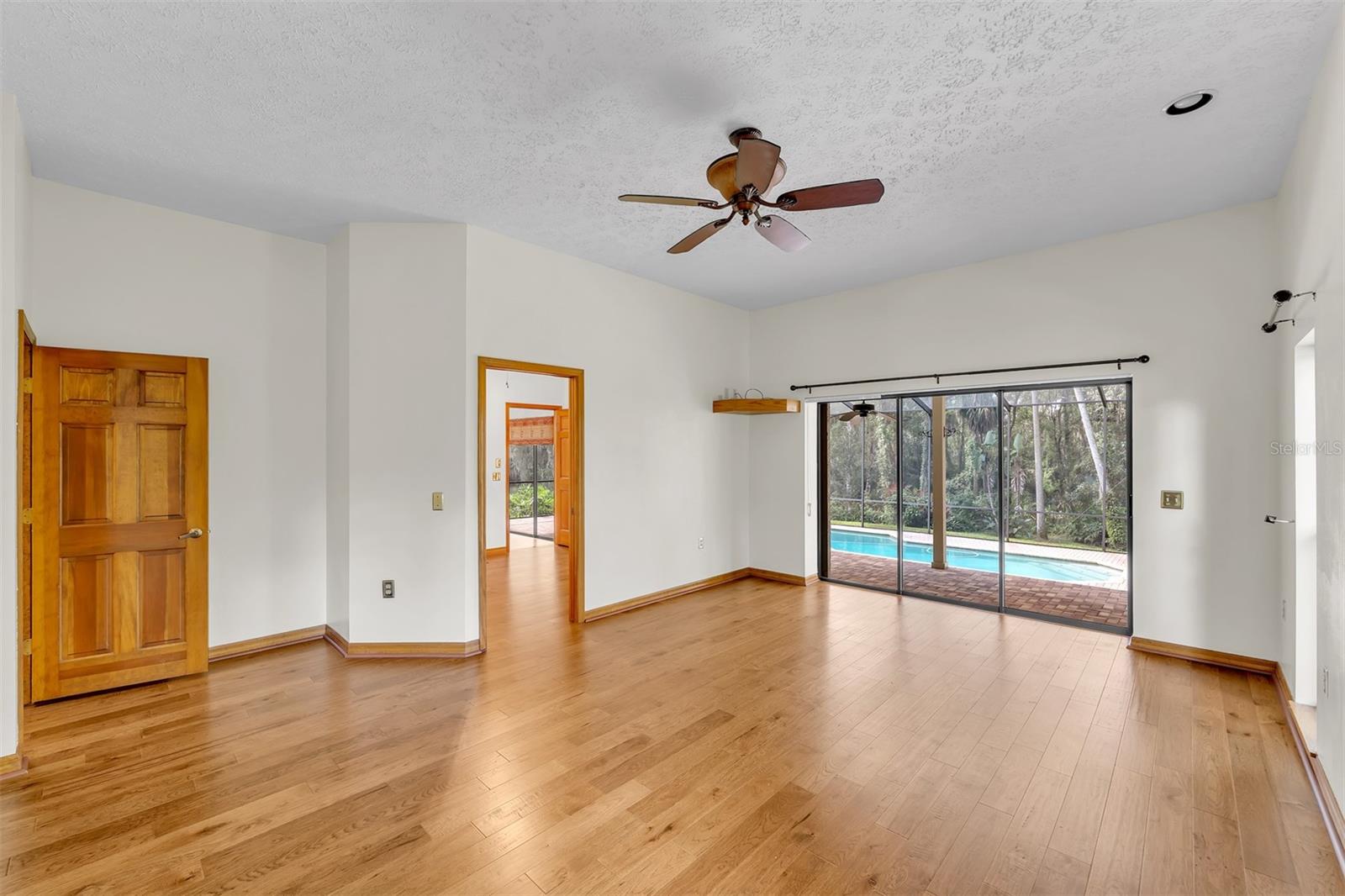 Master Bedroom has great views of the pool and yard along with private den access.