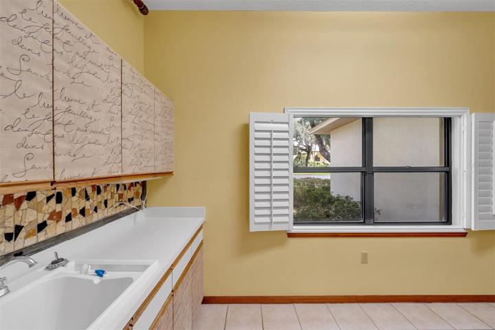 Oversized laundry room with plenty of storage and counter space.
