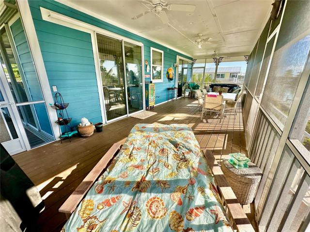 As you walk into the screened front porch,  you will immediately want to curl up and relax with a good book