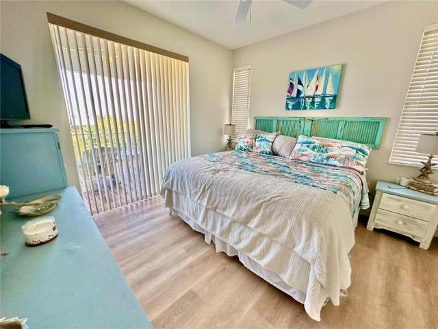 The master bedroom has sliders out to another side patio.