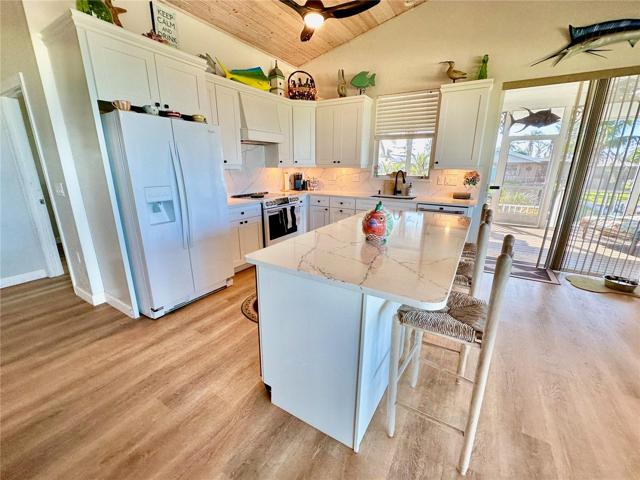 Custom wood cabinetry and Cambria Quartz countertops with matching appliances.