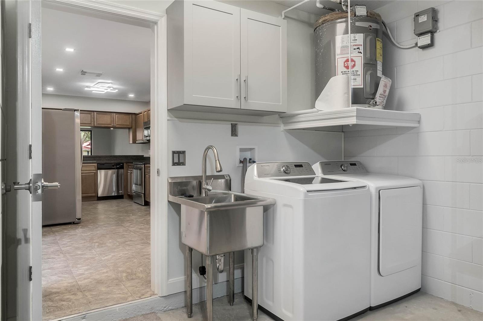 Laundry room and sink in garage.
