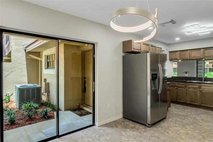 Breakfast Nook in the Kitchen with sliding doors. New Blinds installed throughout