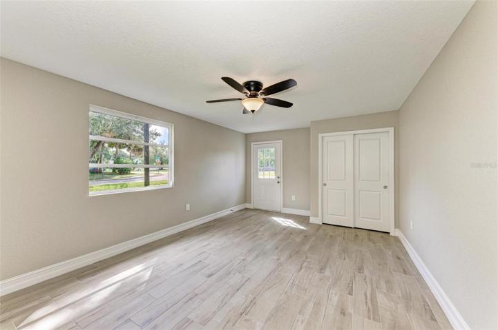 Bedroom 4 with exterior door. Bedroom 5 not pictured, but not to this bedroom.