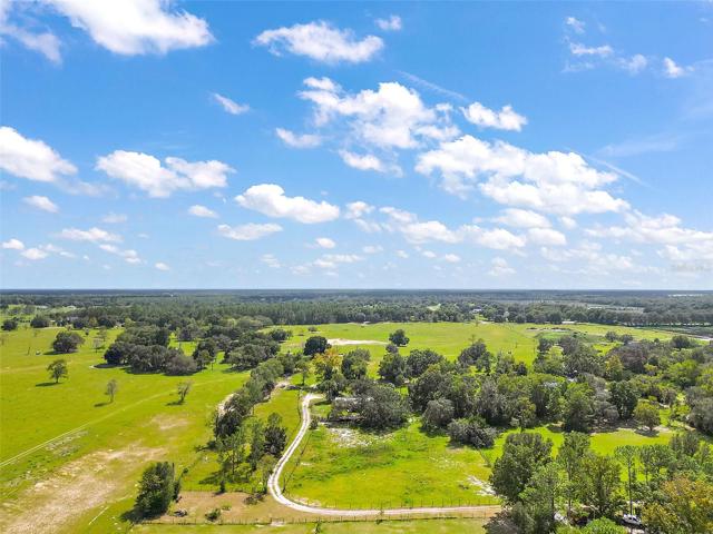 Driveway entrance to the bottom right of photo - which is Westside of Property. Driveway flows east and then south up to the homesite.