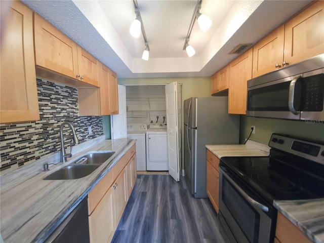 Marble counters, double stainless steel appliances, wood cabinetry and washer dryer closet