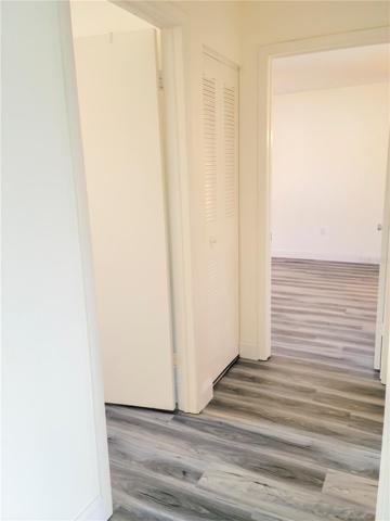 Hallway to bedrooms with luxury vinyl