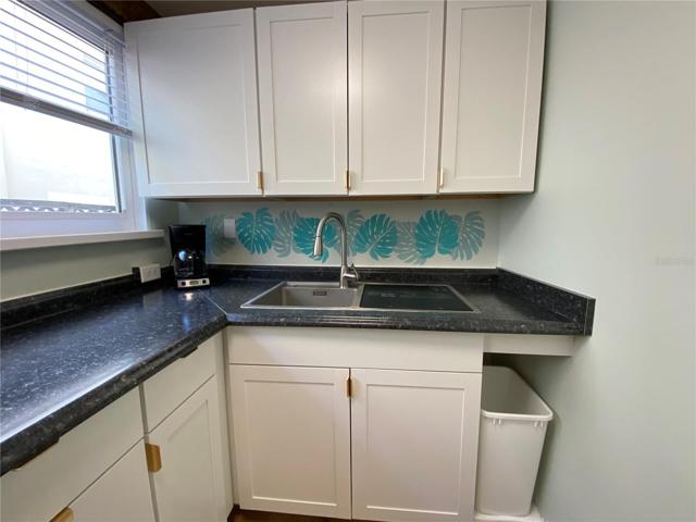 Kitchen - cooktop, small dishwasher, microwave, fridge, dishes and utensils