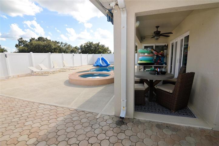 Rear pool deck area with 6' vinyl privacy fence