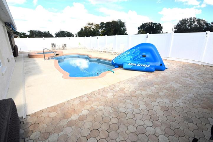 Rear pool deck area with 6' vinyl privacy fence
