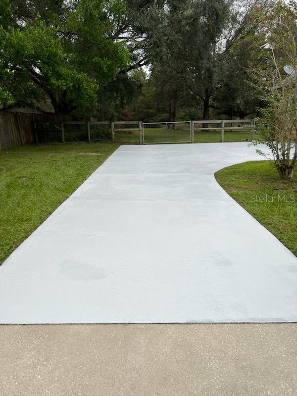 Long driveway has a large parking pad for all your friends and family's vehicles.  Newly refinished driveway surface.