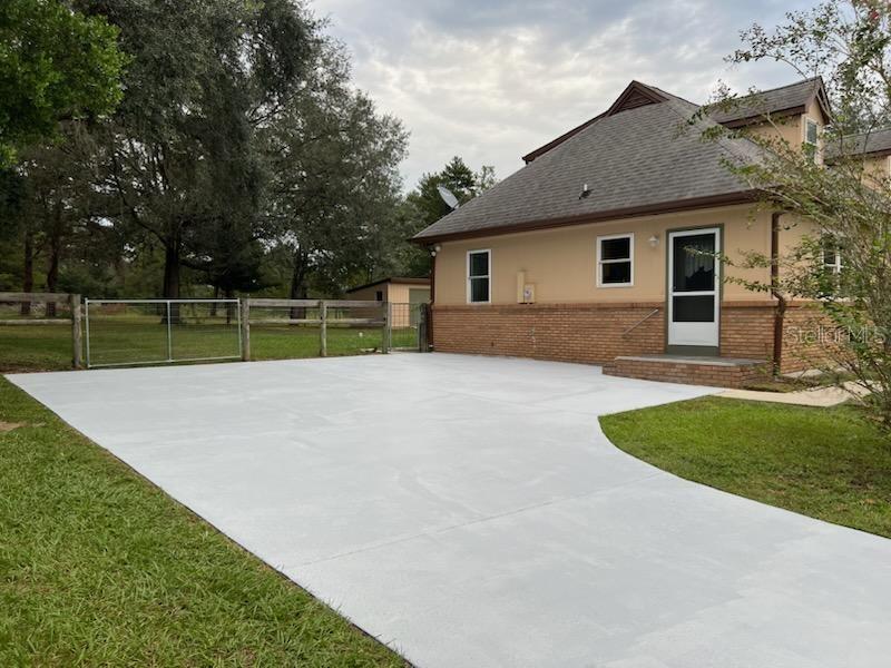 Left side of home.  Long driveway features a large parking pad and there is a vehicle gate to access the fenced back yard.  This door enters into the kitchen which makes it easy to unload groceries.  Sidewalk in front of house leades to large covered front porch and the front living room entrance.