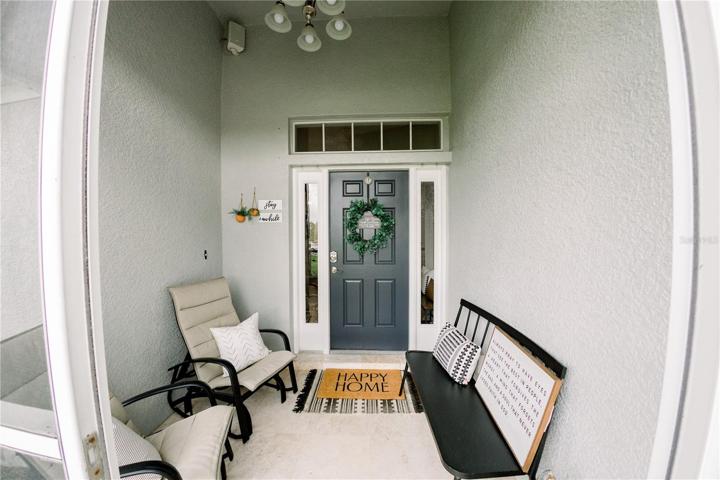 Large screened front porch with high ceiling
