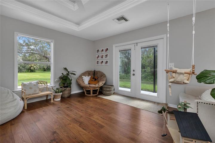 French doors out to screened lanai and paver grilling/sitting/dining patio