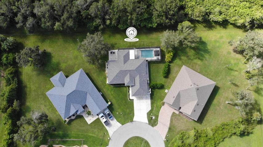 Lush and mature privacy-landscaping makes this yard and pool feel like a tropical oasis