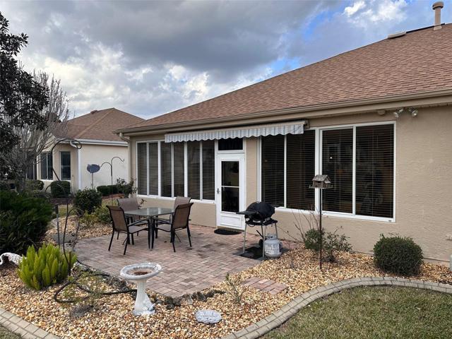 Back patio with shade awning and pavers