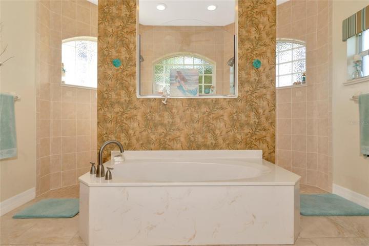 Amazing walk-in shower with a wall of block glass for natural lighting.