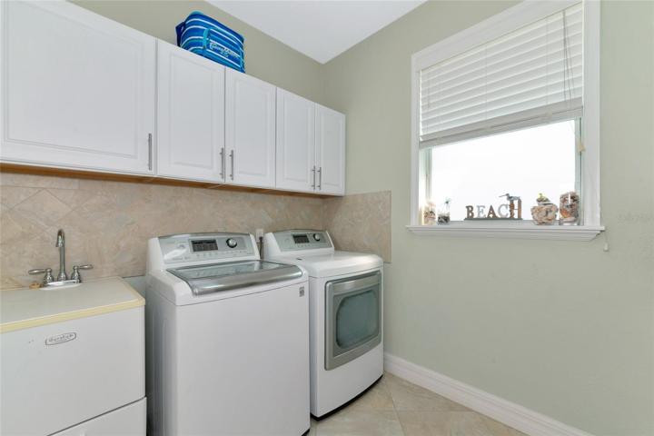 Huge Laundry room with room for another full size fridge on the opposite wall.