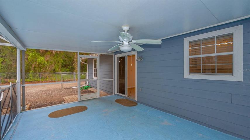 Rear covered and screened lanai with sliding glass doors from living area