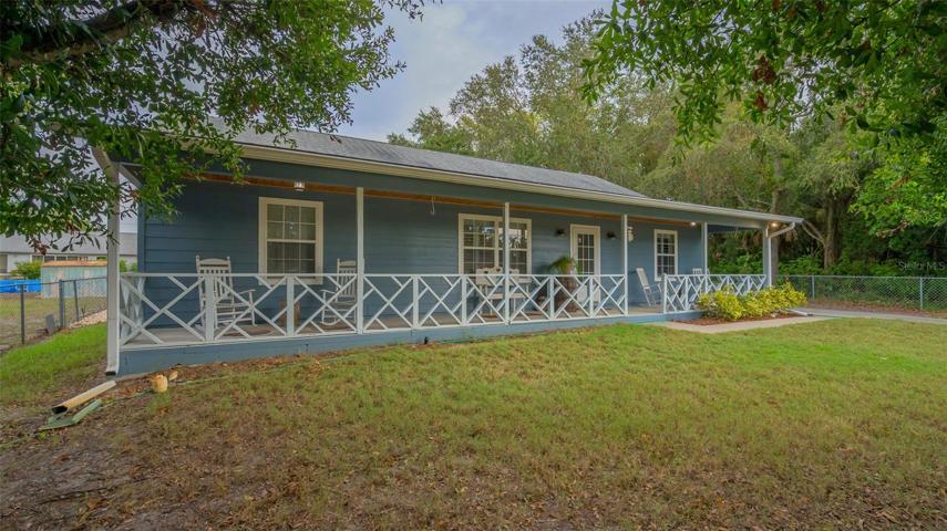 50 x 6 foot covered front porch and chain-linked fenced in yard