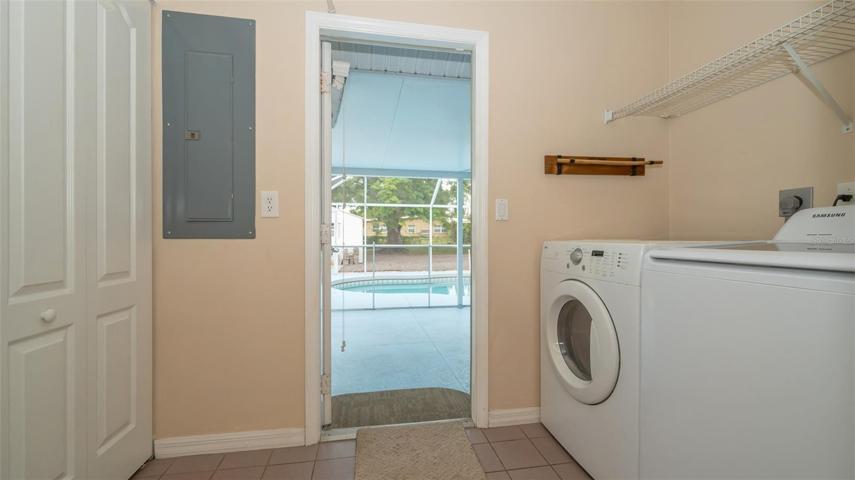 Spacious 6 x 11 inside laundry room with washer dryer opens to pool area