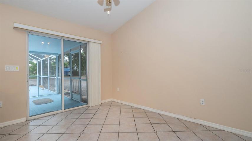 Sliding glass door entry to pool area from combo Dining Room/Kitchen