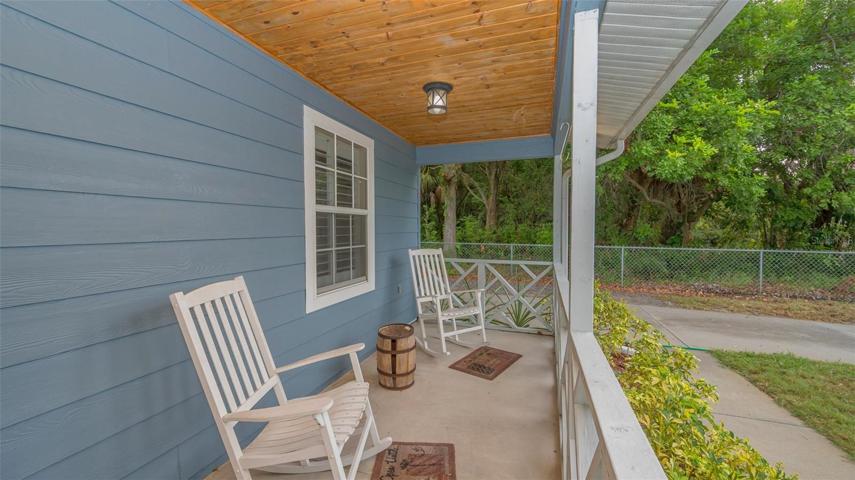 50 x 6 foot covered front porch and chain-linked fenced in yard