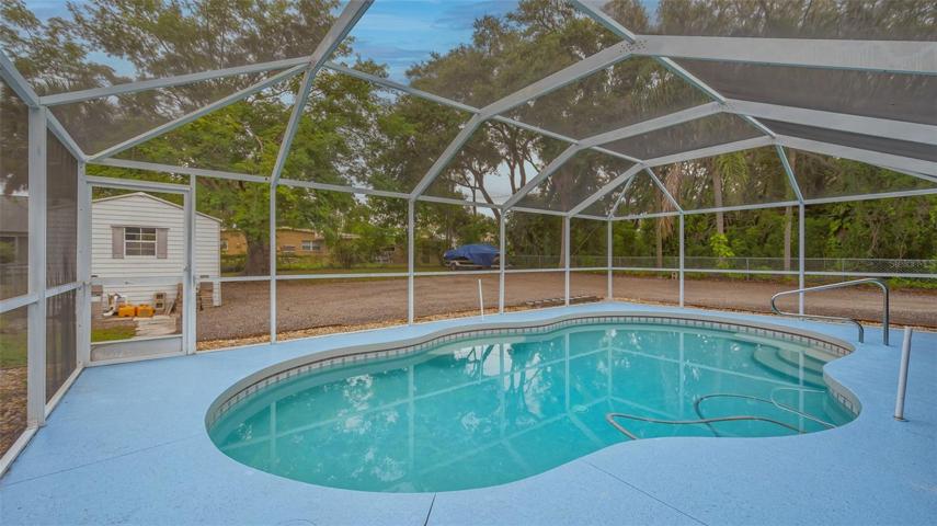 Caged pool overlooking the spacious rear fenced yard