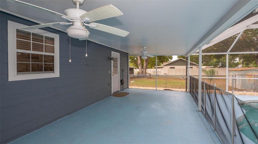 Rear covered and screened lanai with entry door from inside laundry room