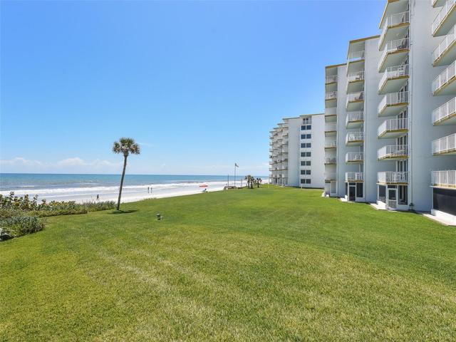 Grassy area between condo and beach.