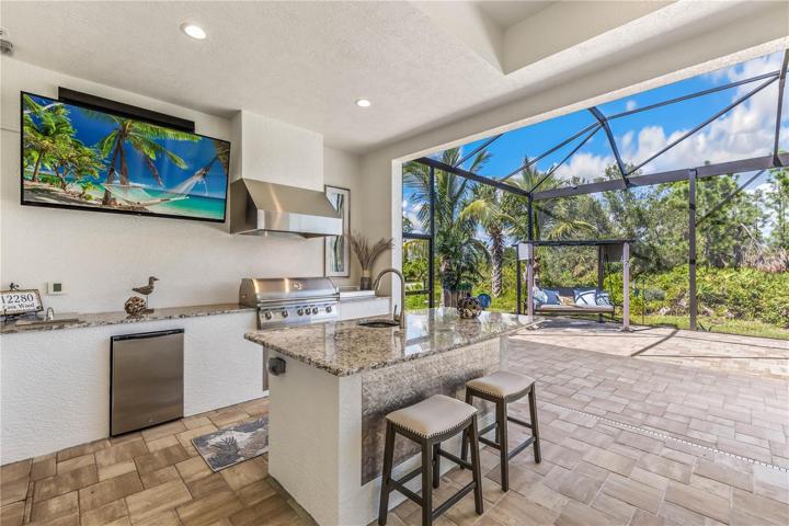 Outdoor Kitchen With Grill + Two Burners, Refrigerator, and Sink