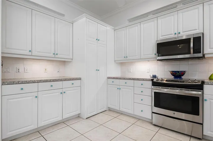 Spacious kitchen with stainless appliances and pantry