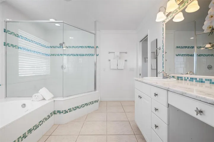 Primary bathroom with dual sinks, walk in shower and soaking tub